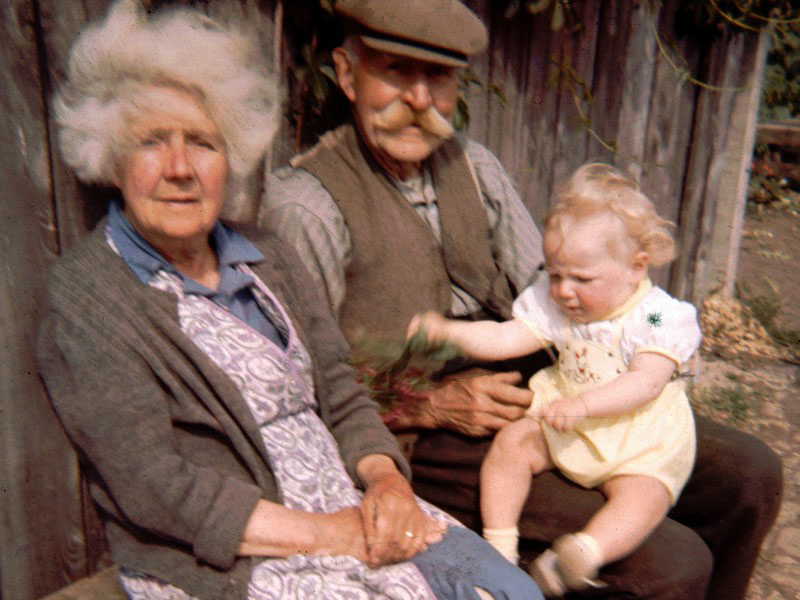 Basil Griffin (‘Griffen’ in list), (Lots 43 & 46) with wife and grandchild, outside his shed.
