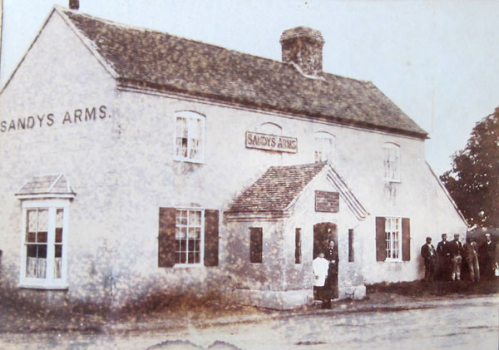 The Sandys Arms in the 1890s with Hannah Pethard and one of her children in the doorway.