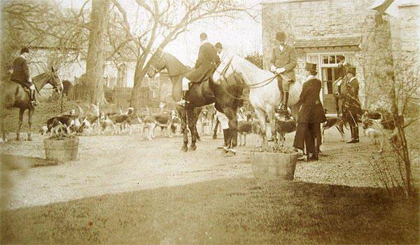 The hunt. The hunt meeting in front of Wickhamford Manor, with the church in the background, probably photographed between the wars.
