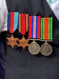 Ian Devine wearing his father William's war-time medals