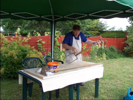 John Dallimore dons his decorating overalls to do a spot of cleaning on a two-tine fork.