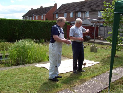 Will Dallimore and Robin Neill look at the cider barrel which once belonged to Tony Jerram.