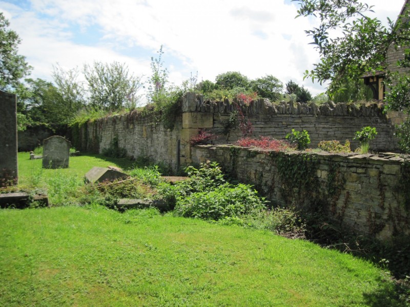 56. This higher part of the Churchyard wall and the adjoining wall dividing the front and rear gardens of the Manor are all that remains of a great stone barn that stood between the Church and the Manor.