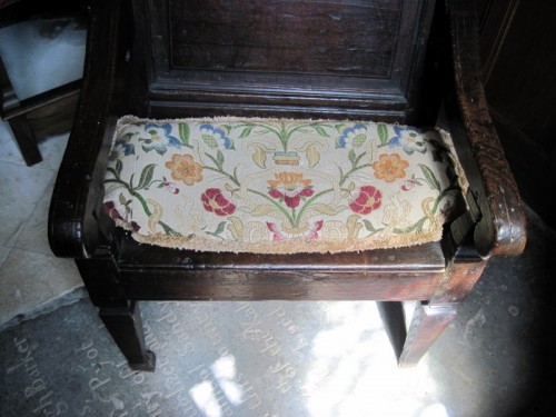 Tapestry in cushion on old chair in the chancel