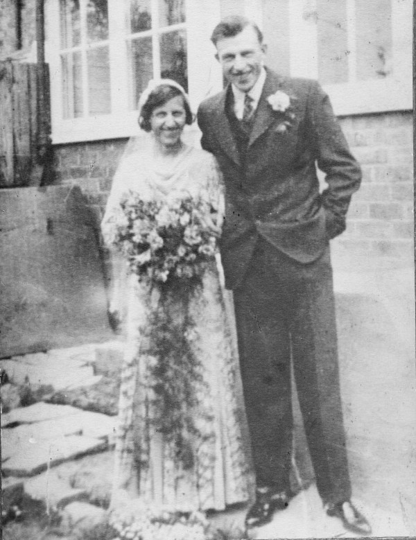 Ernie and Alice Knight [nee Bennett] in their marriage finery in 1931 in the rear garden of the house where they spent their married lifes.