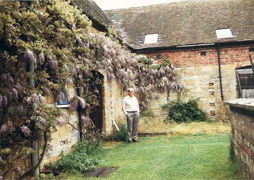 Wisteria covering the east side of Sladdens Barn in the 1970s with Pat Sladden.