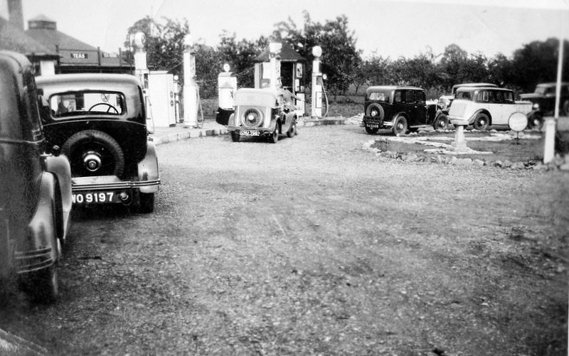 This shows cars on the forecourt, mostly with 1930s registration plates.