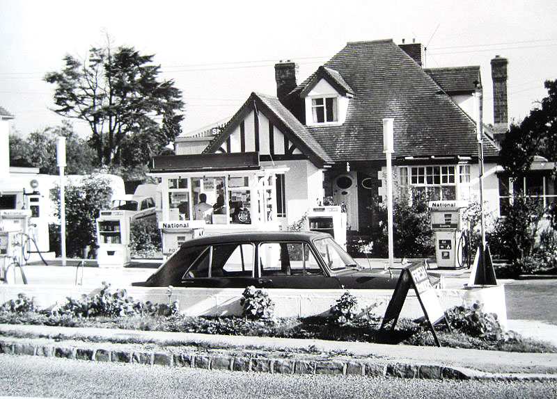 The filling station showing attendant-operated National Benzole petrol pumps