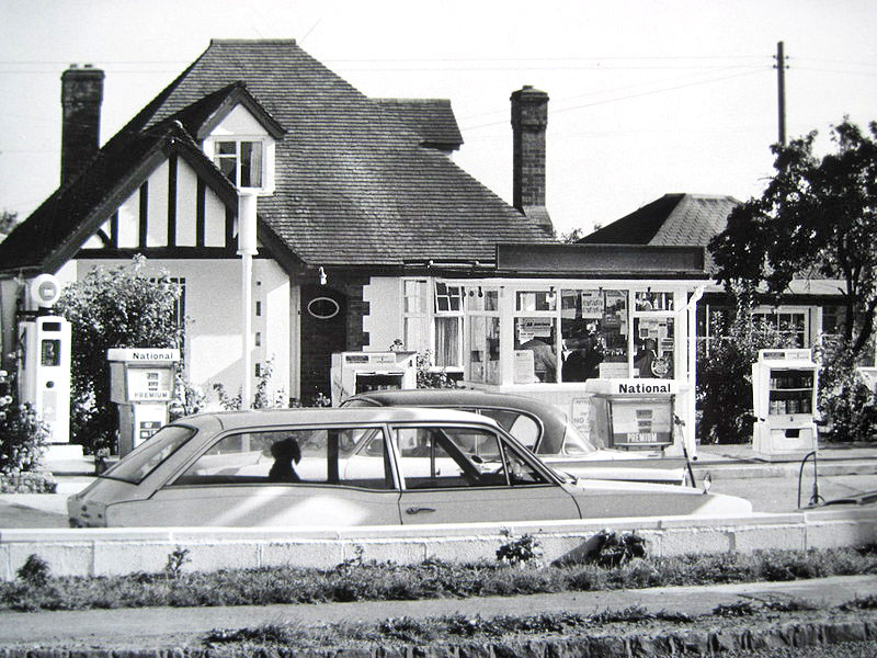 The filling station showing attendant-operated National Benzole petrol pumps