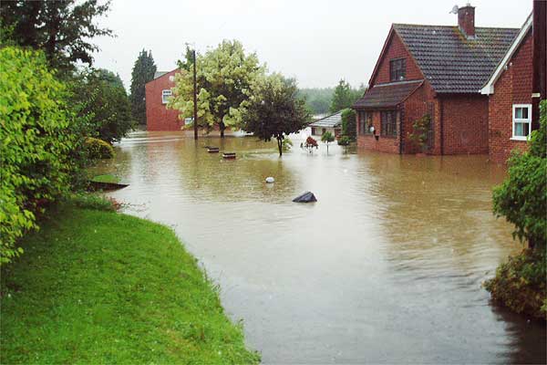 Mill Cottages (1 of 2). The depth of water must have been near its maximum when this was taken on Friday evening. Many houses along Mill Lane became flooded as Badsey Brook expanded. The second picture shows the following morning with water levels down and residents beginning the sad business of sorting out the mess. Figures are not yet available but dozens of other houses in Badsey and Aldington have had rooms filled with water. Photo: Lucy Biltcliffe.