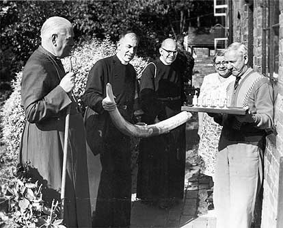 Bertram and Ellen Jones outside Vine Cottage showing an elephants tusk and an ivory chess set.