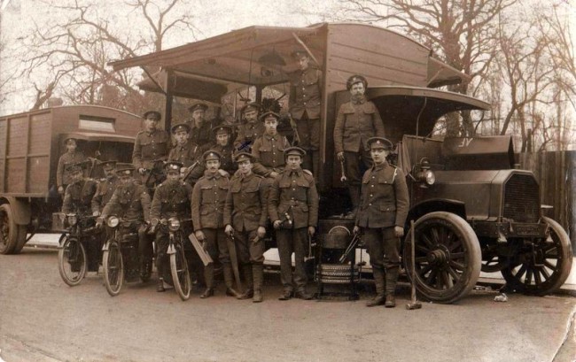 Norris Haines ( X ) with other soldiers and Army transport in France.