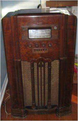 A wireless set housed in a walnut veneer cabinet.