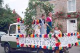 A carnival float pasing Harrington House in 2000