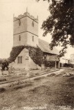 Postcard picture of Wickhamford Church.  The lower tower is covered in ivy.  Based on the gravestones, this photograph would seem to date from the 1930s.