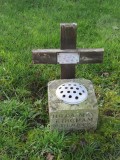 Vase and wooden cross with metal plaque