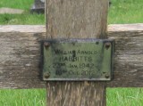 Plaque on wooden cross